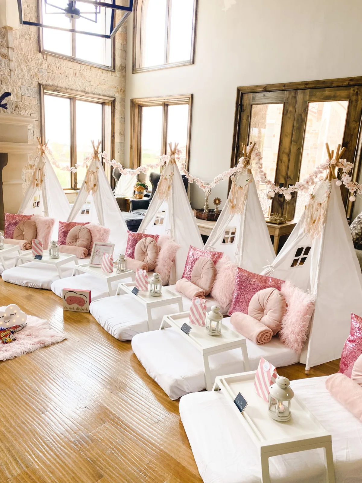 Row of blush teepees with sequin pillows and dream catchers