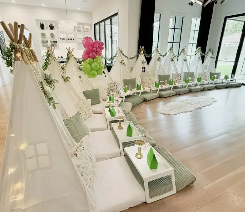 Sage and white teepee sleepover with a pink and green balloon garland