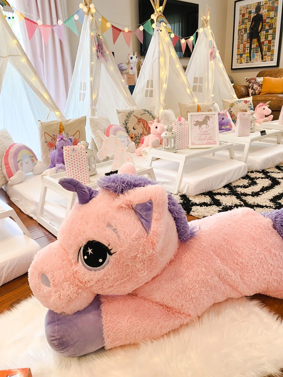 Unicorn themed teepee sleepover with a giant plush unicorn