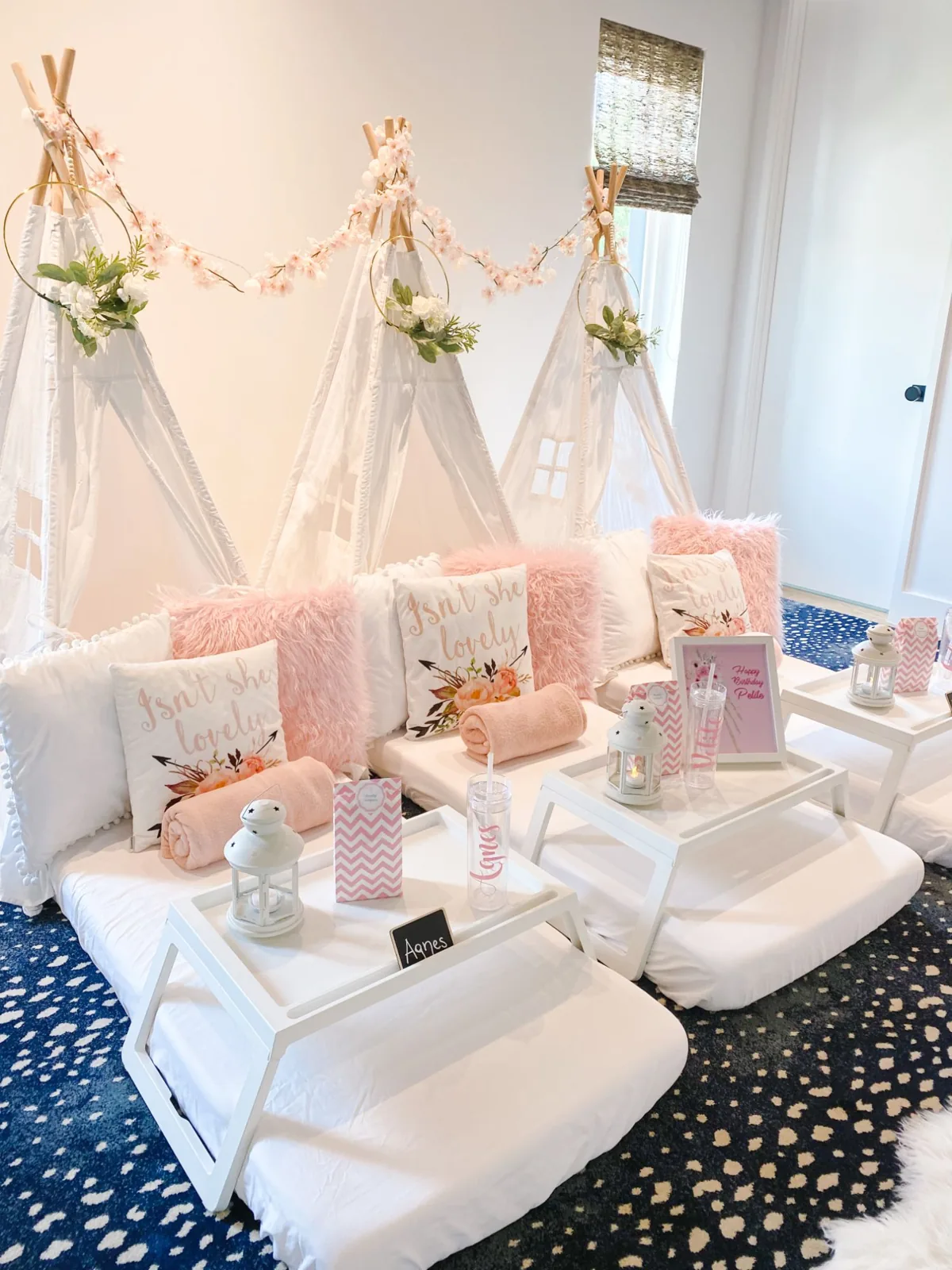 Blush teepee sleepover with floral hoops and name trays